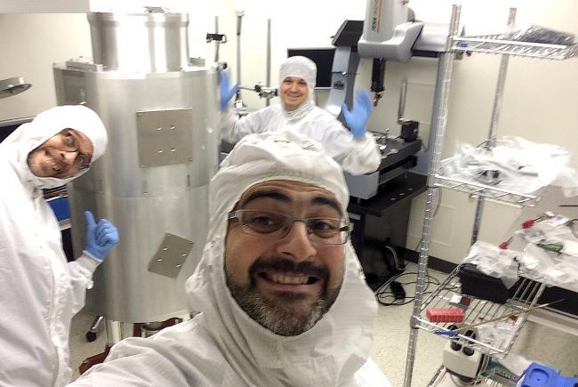 Cryogenic test of the SPIRou spectrometer in a clean room. Olivier Hernandez in the foreground, and, from left to right: Loïc Albert and Philippe Vallée.