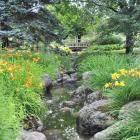 A small rustic bridge and flowers at the Flowery Brook. 